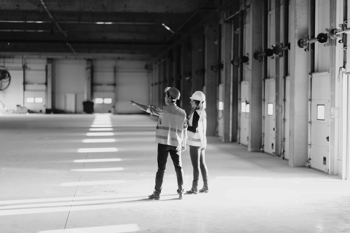 Construction worker explaining the building specifications to a woman